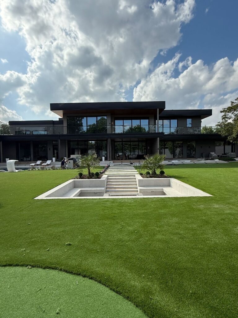 The same modern backyard after completion, with finished pool, steps and new lawn