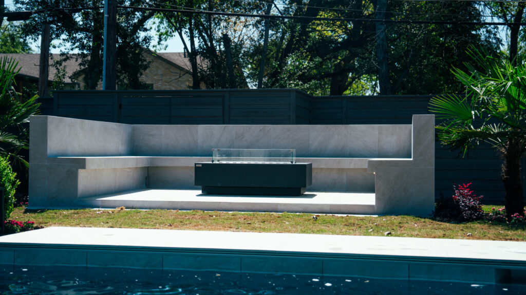 Raised stone spa wall with built-in bench and sheer descent spillway