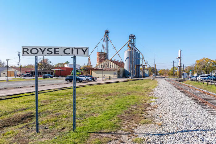 Royse City, Texas sign with grain elevators in the background