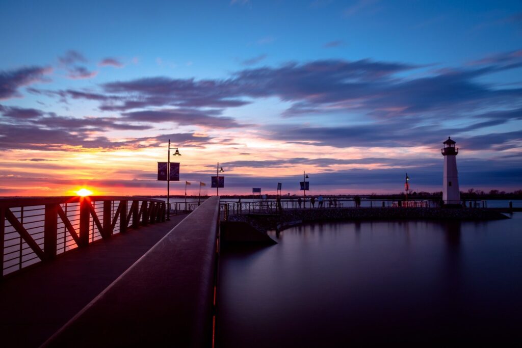 Rockwall Harbor lighthouse and pier at sunset on Lake Ray Hubbard