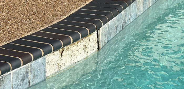 Missing and cracked waterline tile on a pool that needs a pool renovation